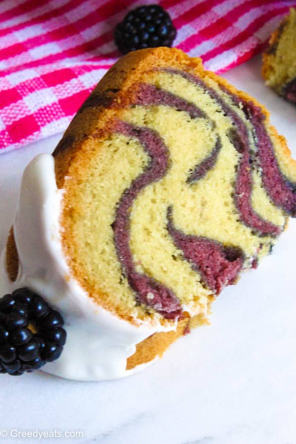 Vanilla bundt cake with blackberry swirls and vanilla glaze