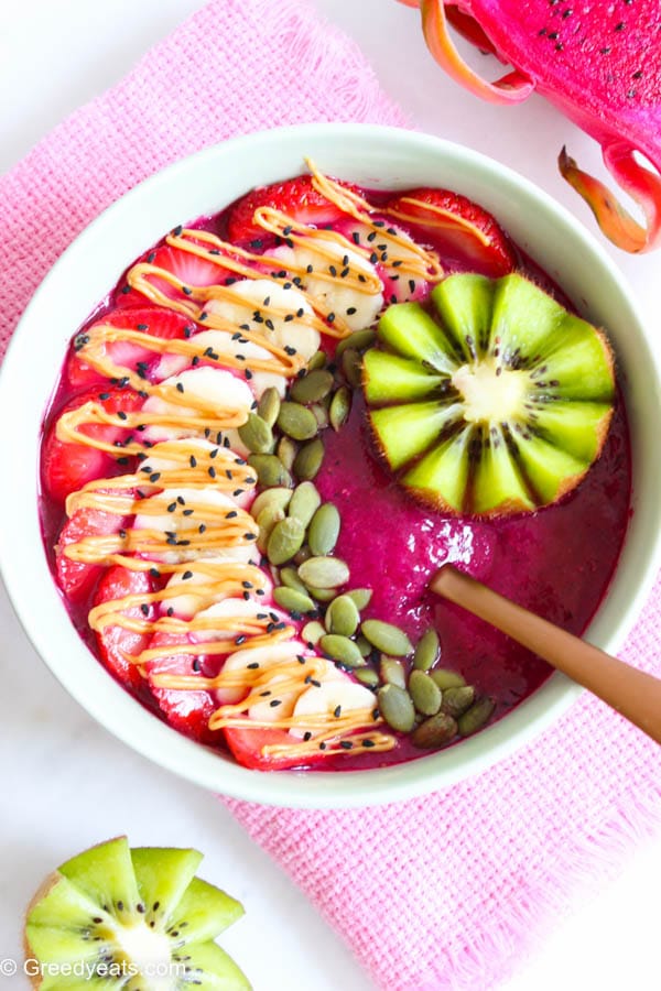 Dragon fruit smoothie bowl with kiwi, strawberry and seeds