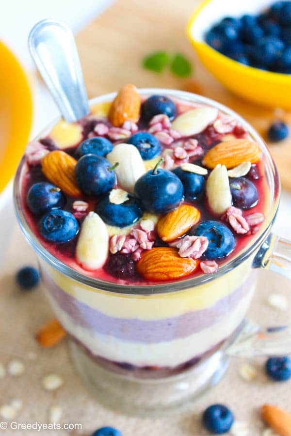Tropical overnight oatmeal in a jar with mango, berries and nuts