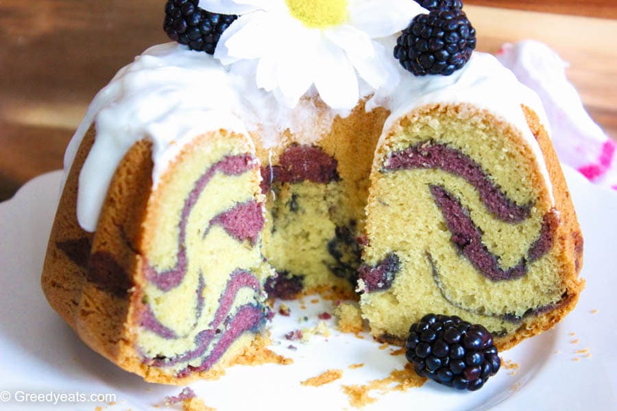 Vanilla bundt cake with blackberry swirls and vanilla glaze