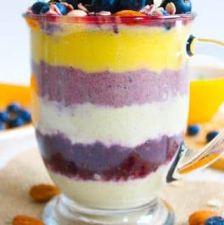 Layered overnight oatmeal in a jar with mango and berries