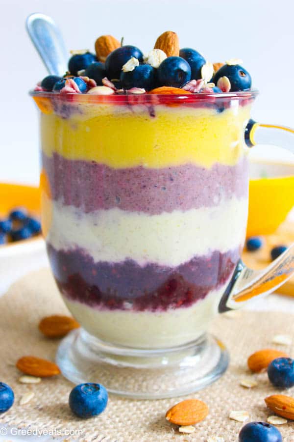 Layered overnight oatmeal in a jar with mango and berries