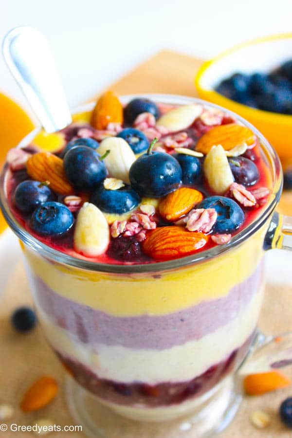 Overnight oatmeal in a jar with mango, berries and nuts