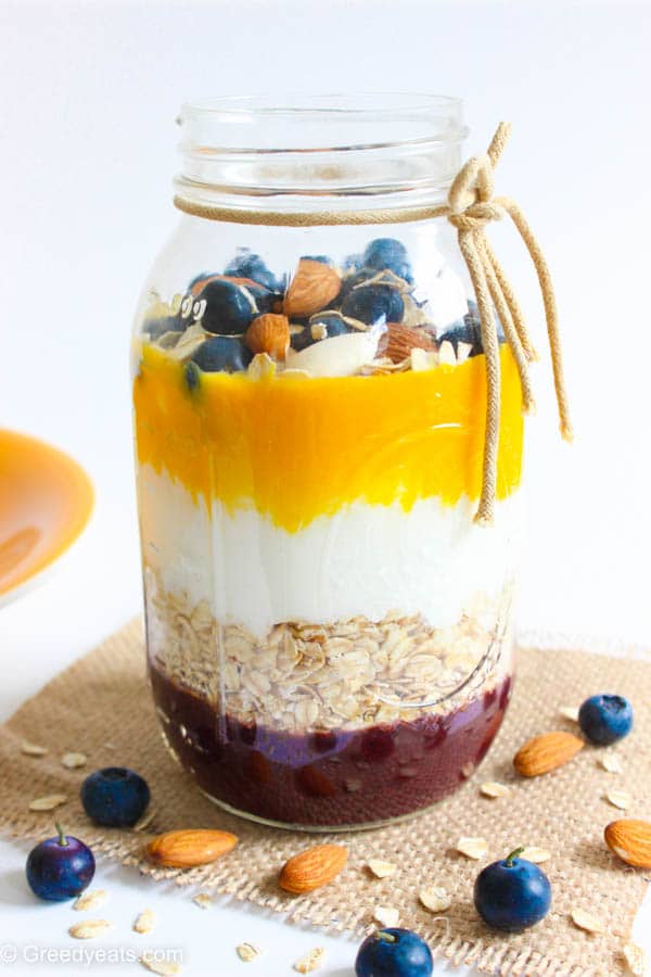 Overnight oatmeal in a jar with mango and berries