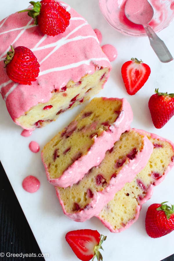 Strawberry Bread Slices covered in fresh Strawberry Glaze on a white board.