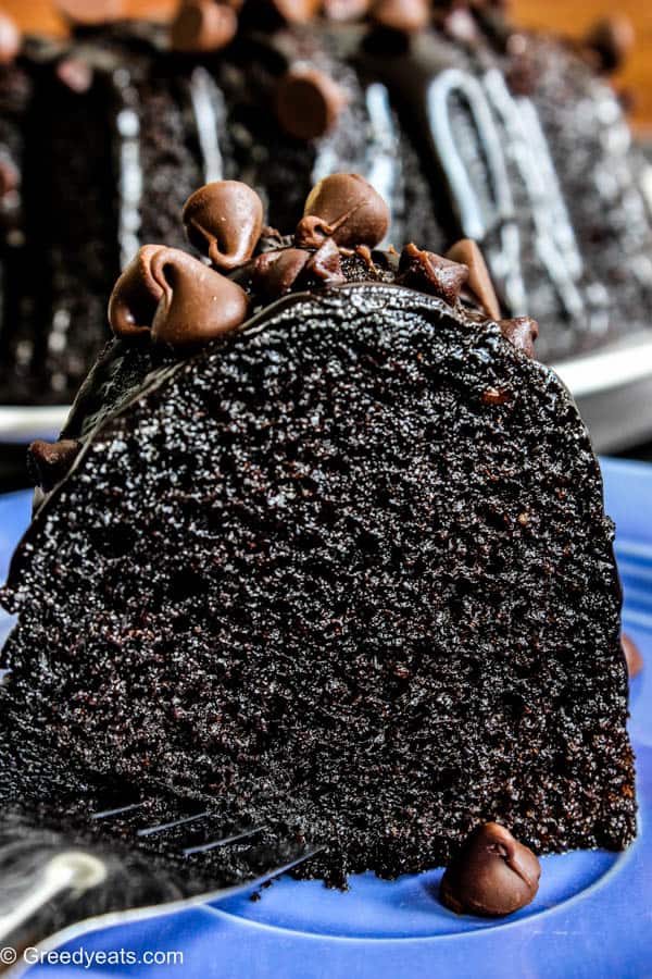 Easy and moist chocolate bundt cake slice topped with homemade chocolate ganache.