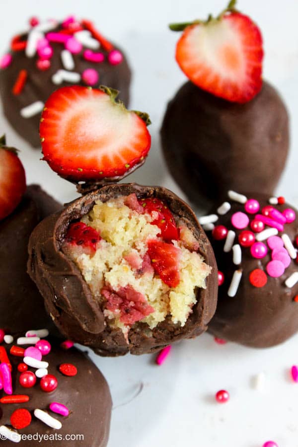 Strawberry cake pops with chocolate coating and sprinkles