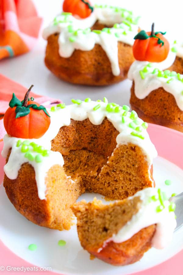 Soft and moist Pumpkin Bundt Cakes with green sprinkles on a fall plate. 