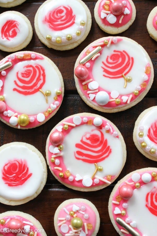 Rose cookies decorated on a sugar cookie recipe with royal icing