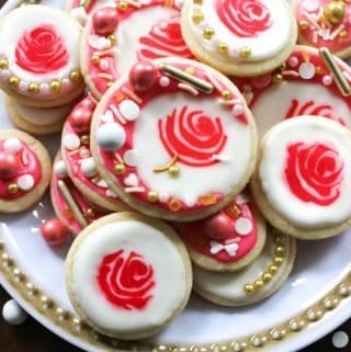 Easy cut out sugar cookie recipe decorated as rose cookies is perfect for valentines! These cookies are topped with royal icing and sprinkles.
