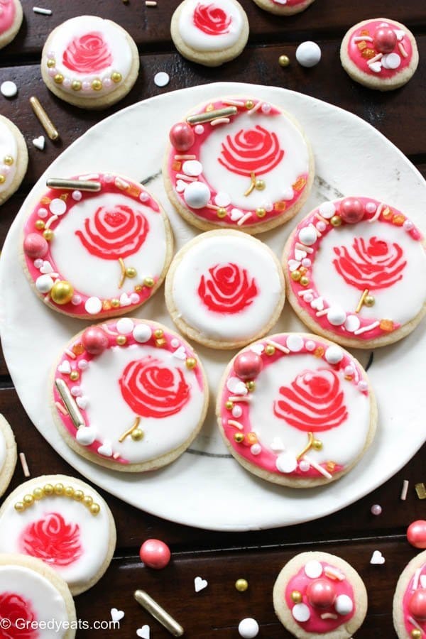 Frosted, soft, buttery and melt in your mouth sugar cookie recipe. I used royal icing to frost these as rose cookies. The most beautiful valentines cookies around!