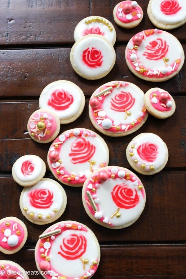 Soft, buttery and melt in your mouth rose cookies for valentines day! These are frosted with an easy royal icing and sprinkles for a little crunch.