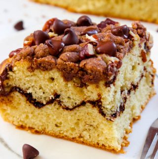 Best cinnamon coffee cake recipe ever! Topped with a thick cinnamon crumb, chocolate chips and pecans. The cinnamon crumb is to die for rich, buttery and is scented with a hint of ginger.