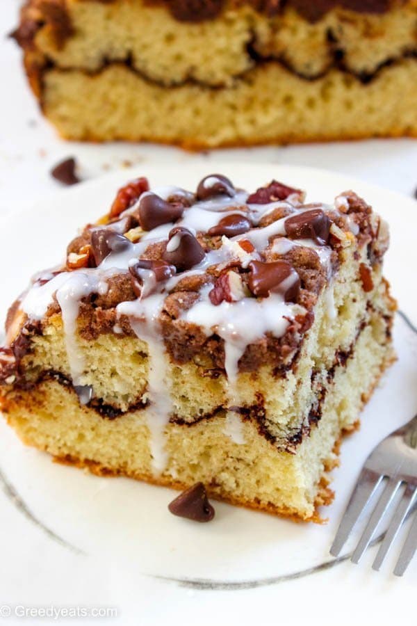 Piled high with buttery cinnamon crumb, layered with chocolate and topped with vanilla glaze this coffee cake will win your heart!