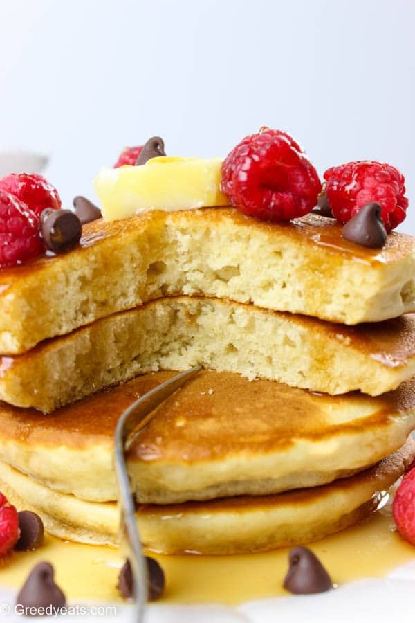 Oh-so-fluffy, quick and easy pancakes served with butter, raspberries, syrup and chocolate chips.