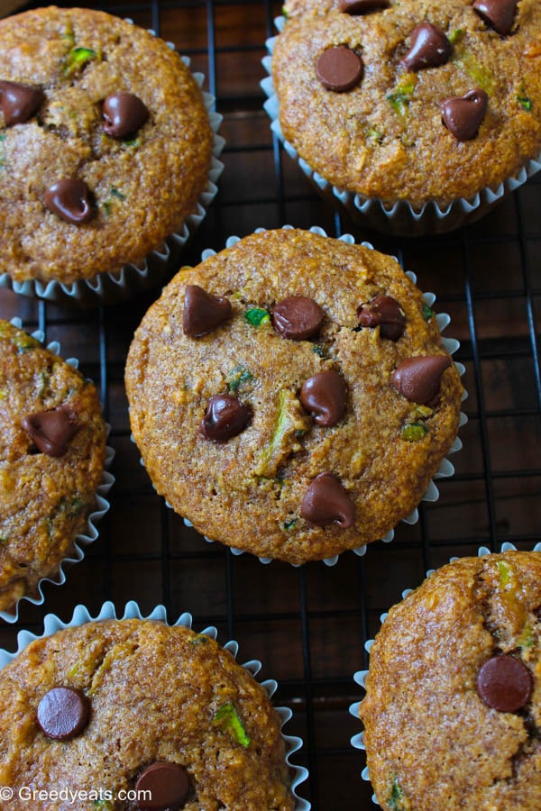 Banana blender muffins with chocolate chips and zucchini on a wire stand.