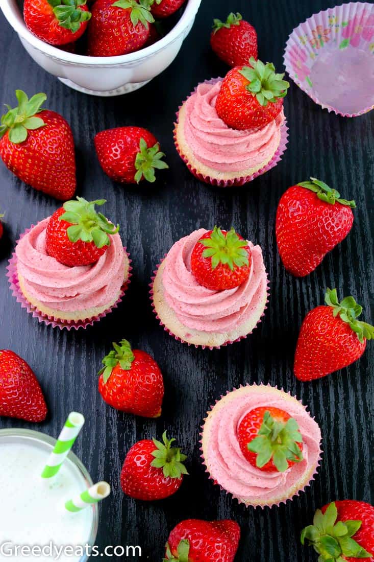 Homemade Strawberry Cupcakes topped with real Strawberry Buttercream and Fresh Berries.