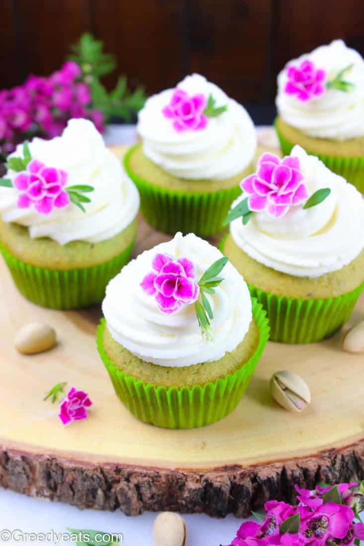 Pistachio cupcake recipe scented with real pistachios flavor and piled high with fluffy vanilla frosting