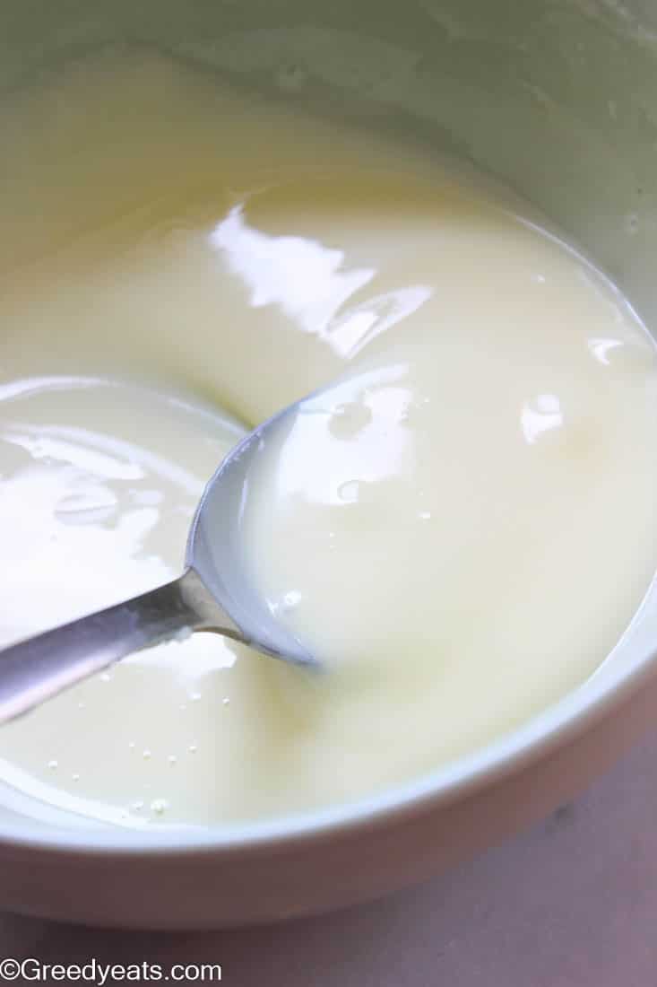 Thick condensed milk cooling in a bowl.