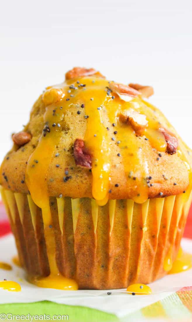 Tall, fluffy and easy orange muffins dotted with poppy seeds and drizzled with orange glaze.