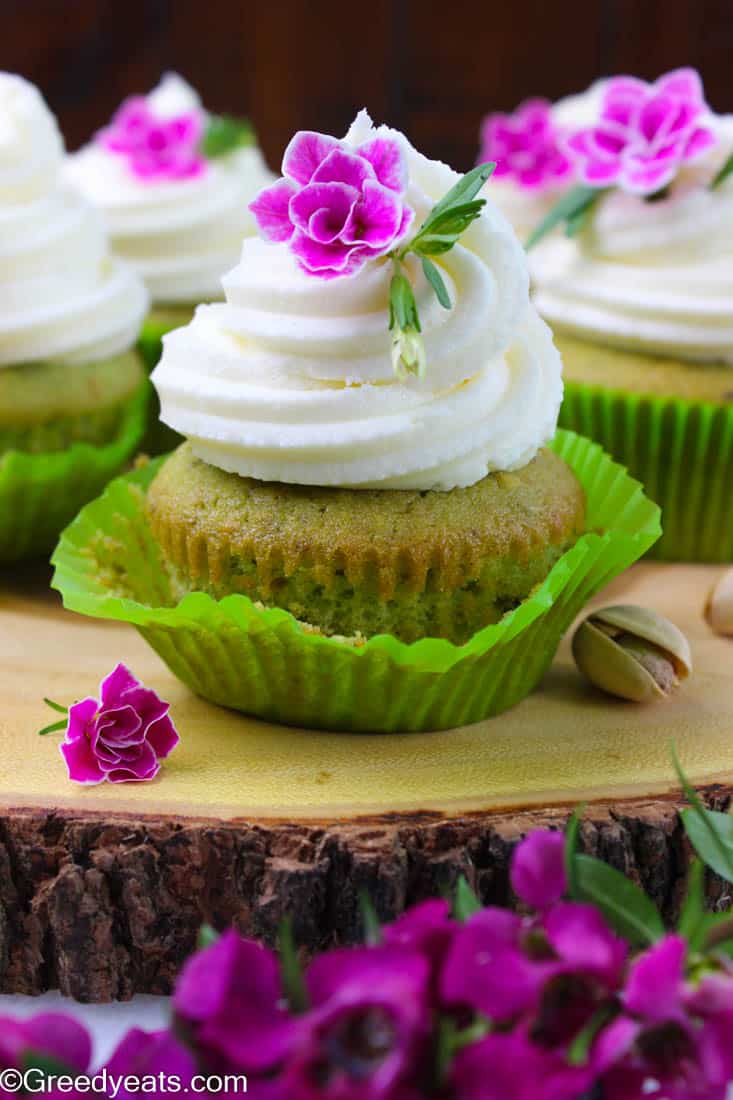 Easy pistachio cupcake recipe with real pistachio crumbs, sour cream and cake flour. These are frosted with dreamy vanilla buttercream.