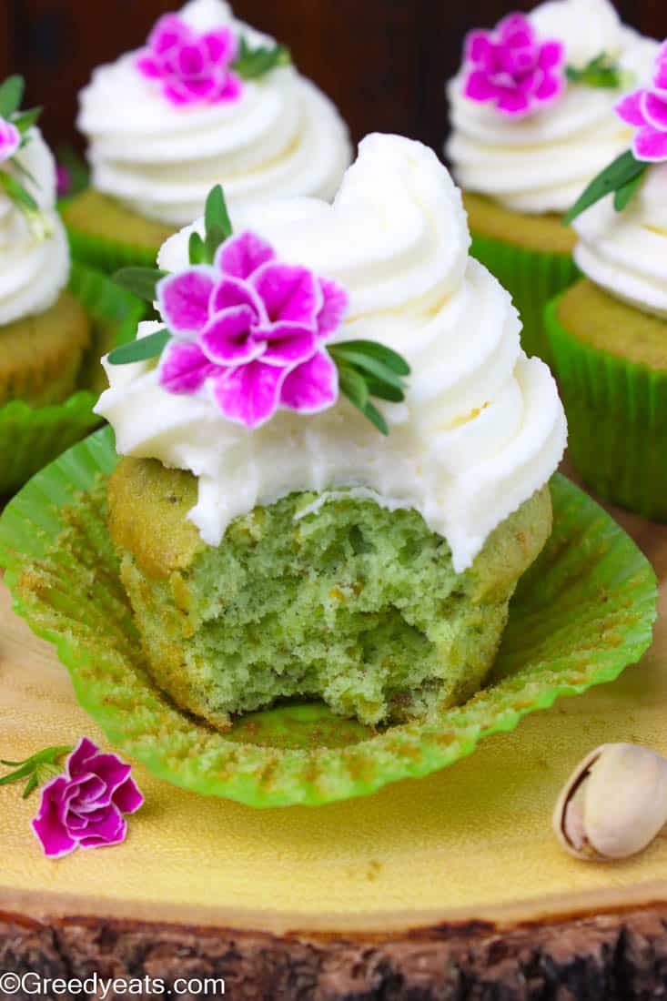 Soft and tender pistachio cupcakes that bake so fluffy! Frosted with vanilla buttercream these are my favorite nut cupcakes!