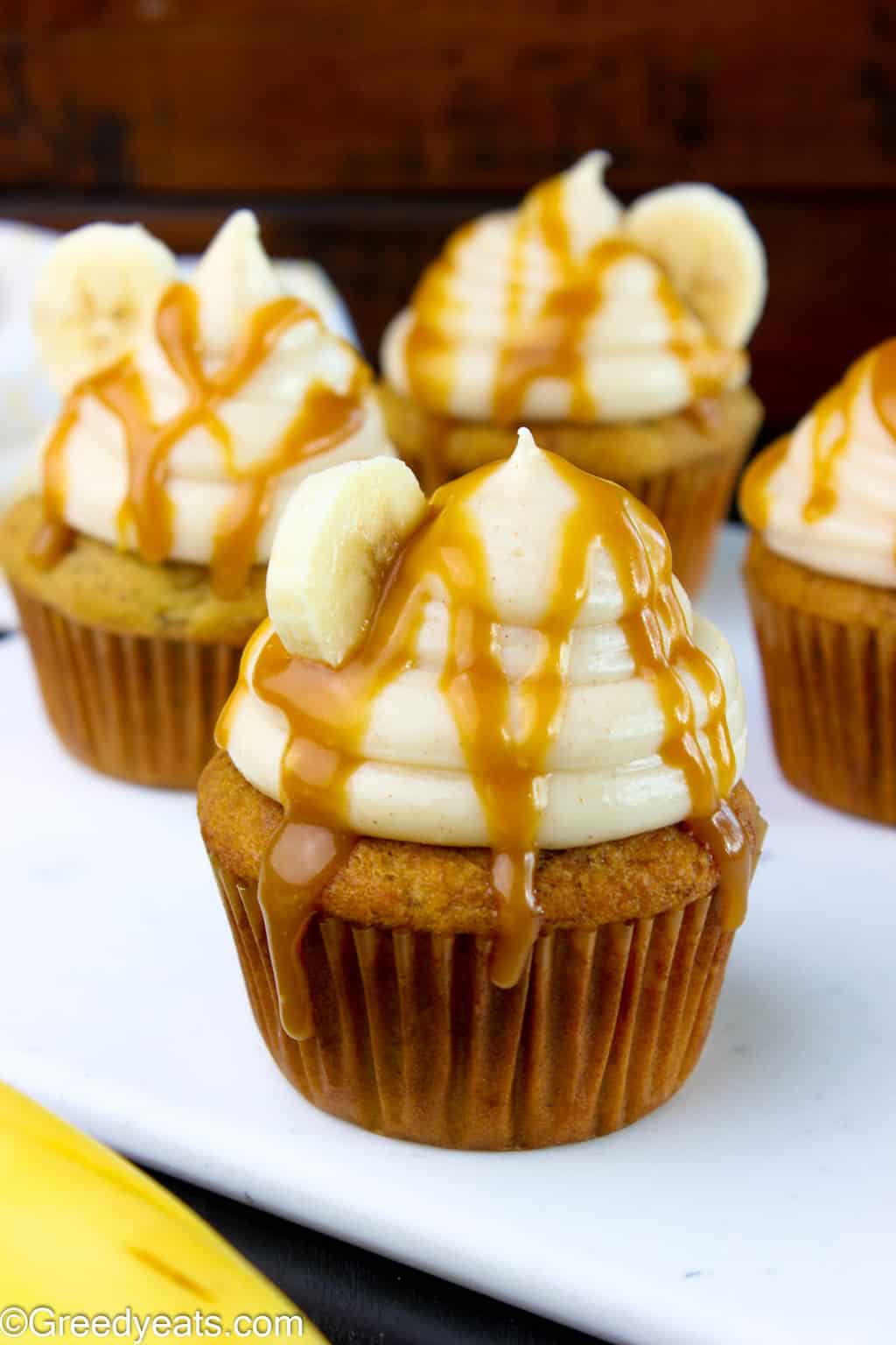 Soft and tender Banana cupcakes with creamy cinnamon cream cheese frosting and caramel drizzle.!