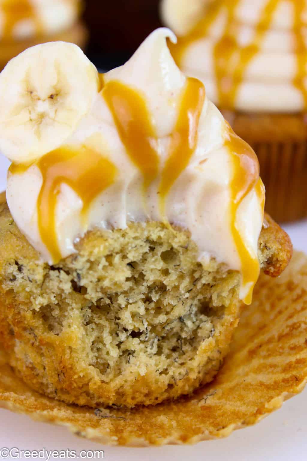 Easy banana cupcakes with spiced cream cheese frosting and a drizzle of caramel is the best way to celebrate fall!