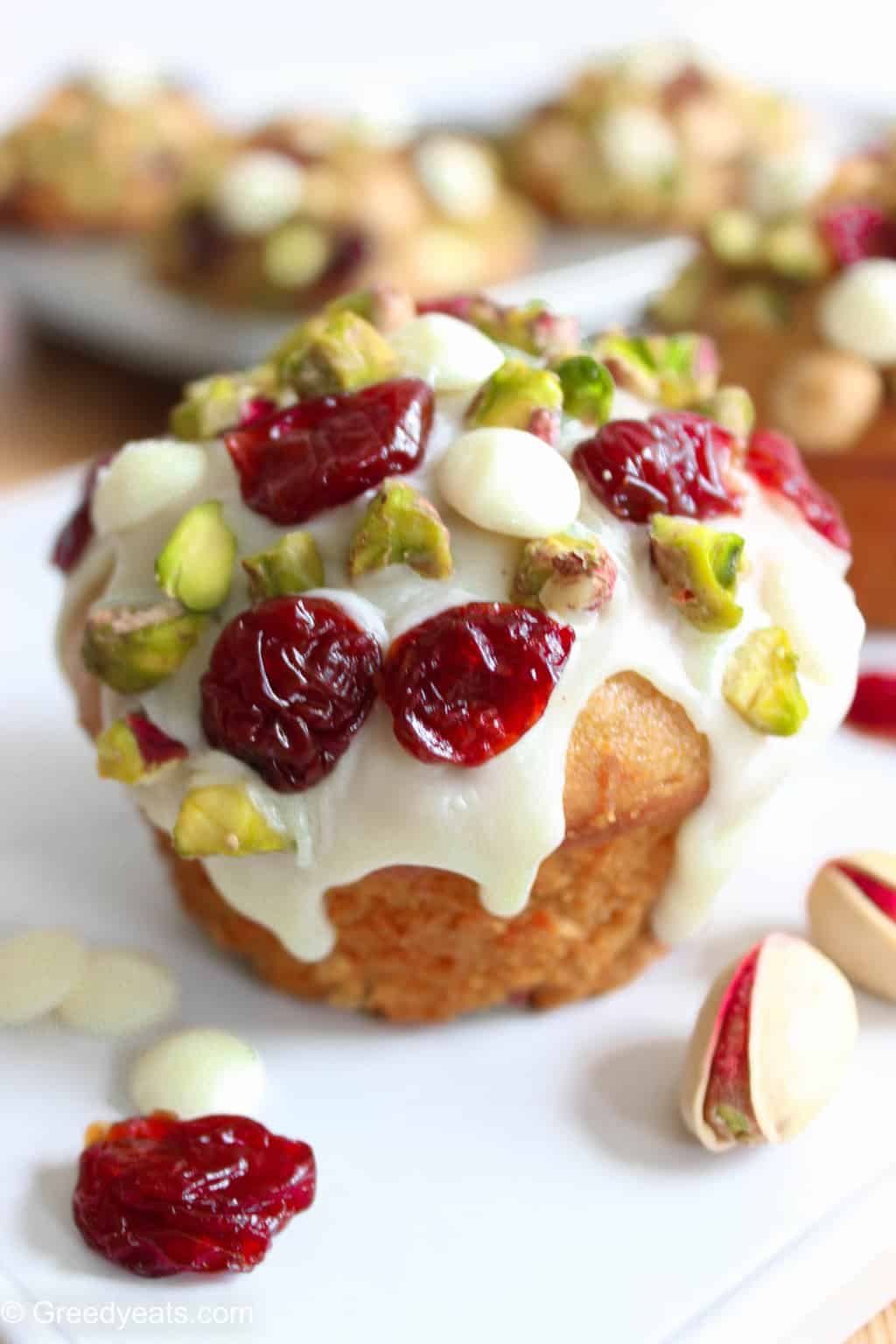 My Cranberry Orange Muffin Recipe bakes super tall and is drizzled with white chocolate.