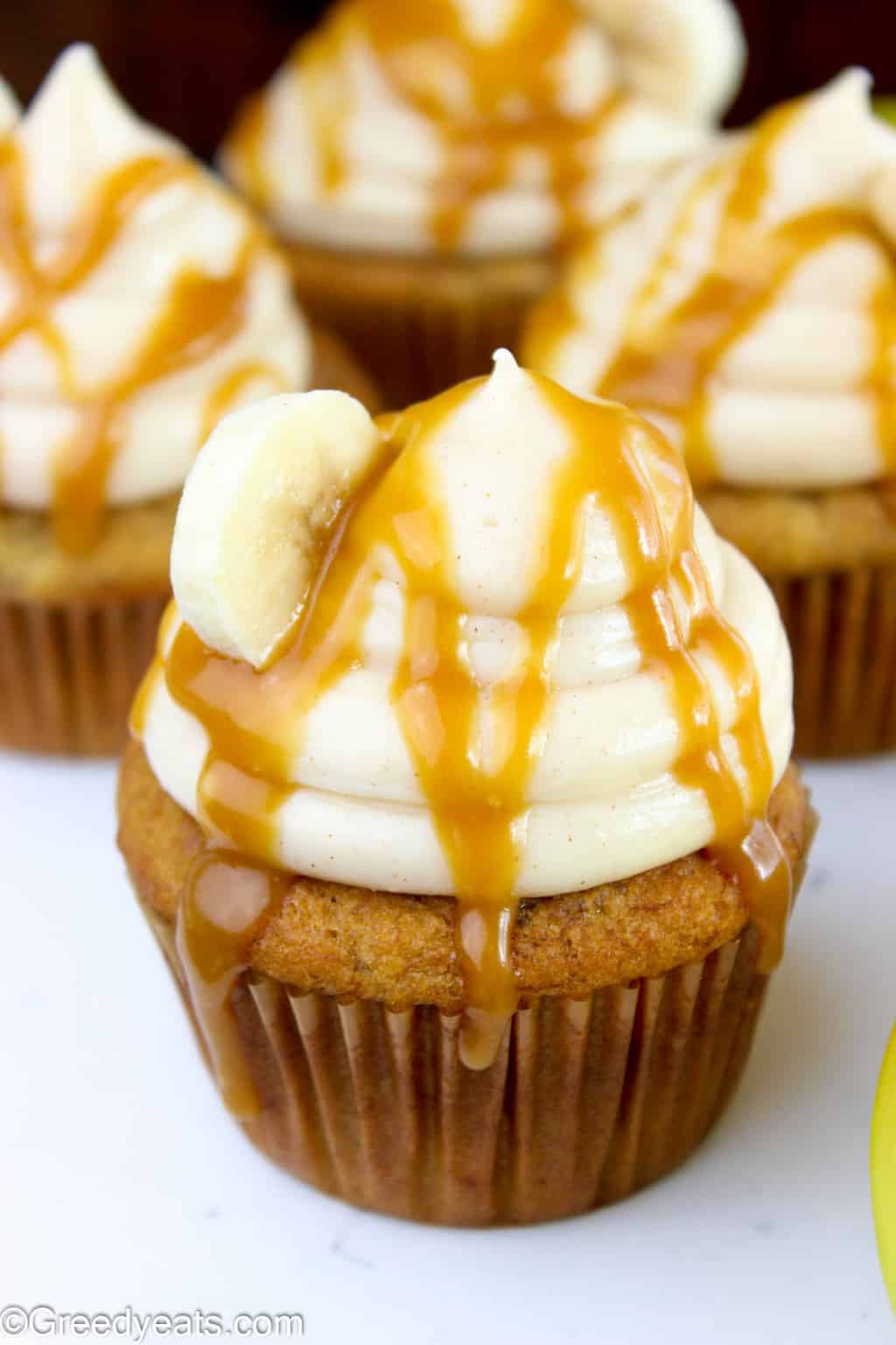 Rich, creamy and cinnamon spiced cream cheese frosting sits of top of these fluffy banana cupcakes