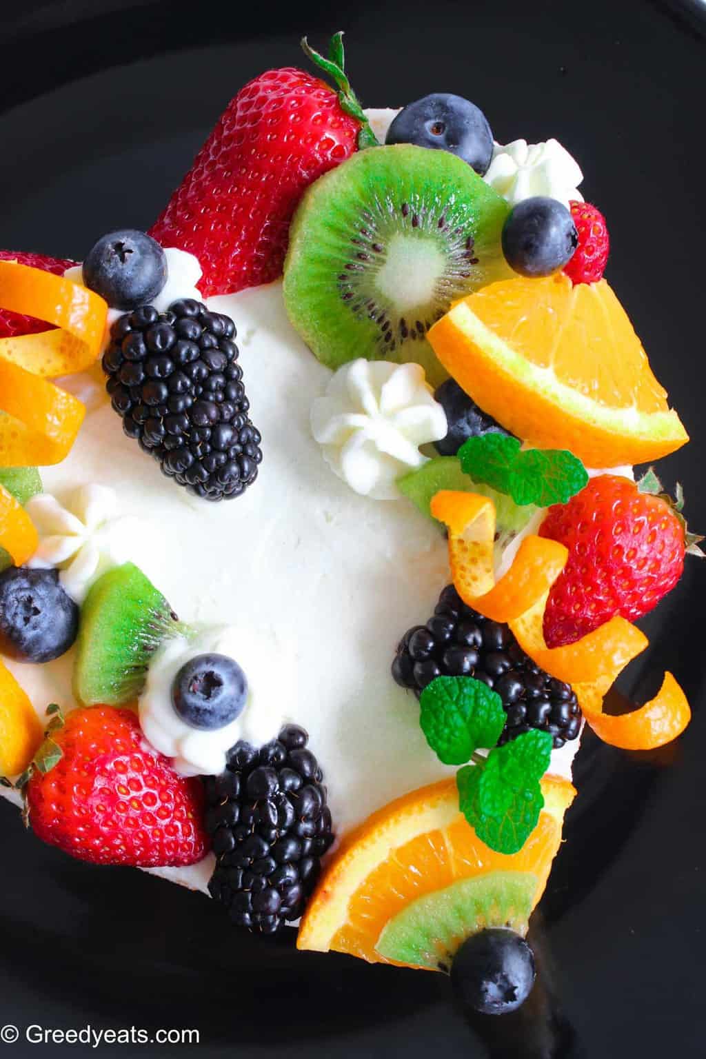 https://greedyeats.com/wp-content/uploads/2019/10/Orange-chiffon-cake-with-fresh-fruits.jpg