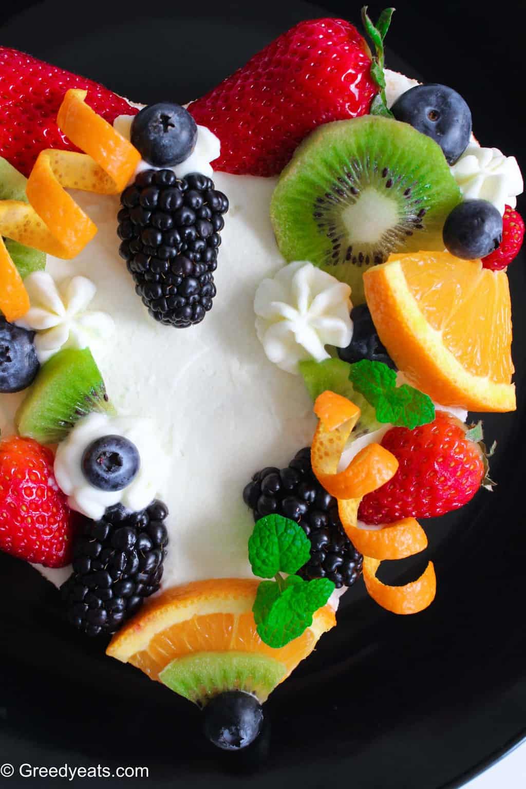 Light, fluffy and moist chiffon cake, bursting with orange flavors, served with fresh fruits.