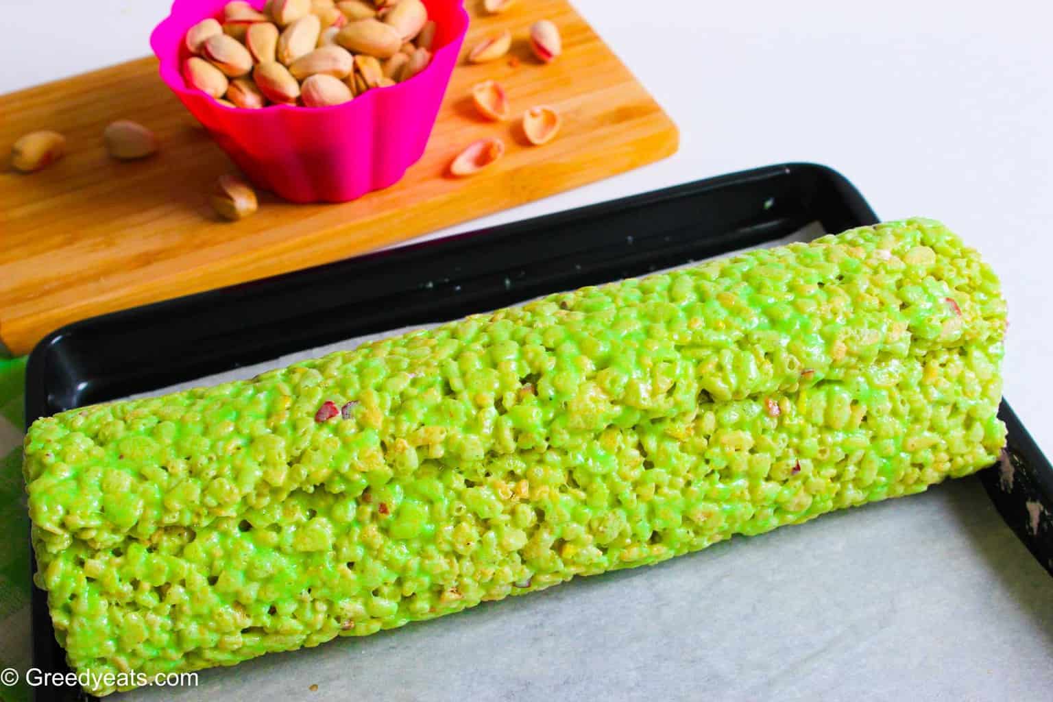 Rolled rice krispie log on jelly roll pan.