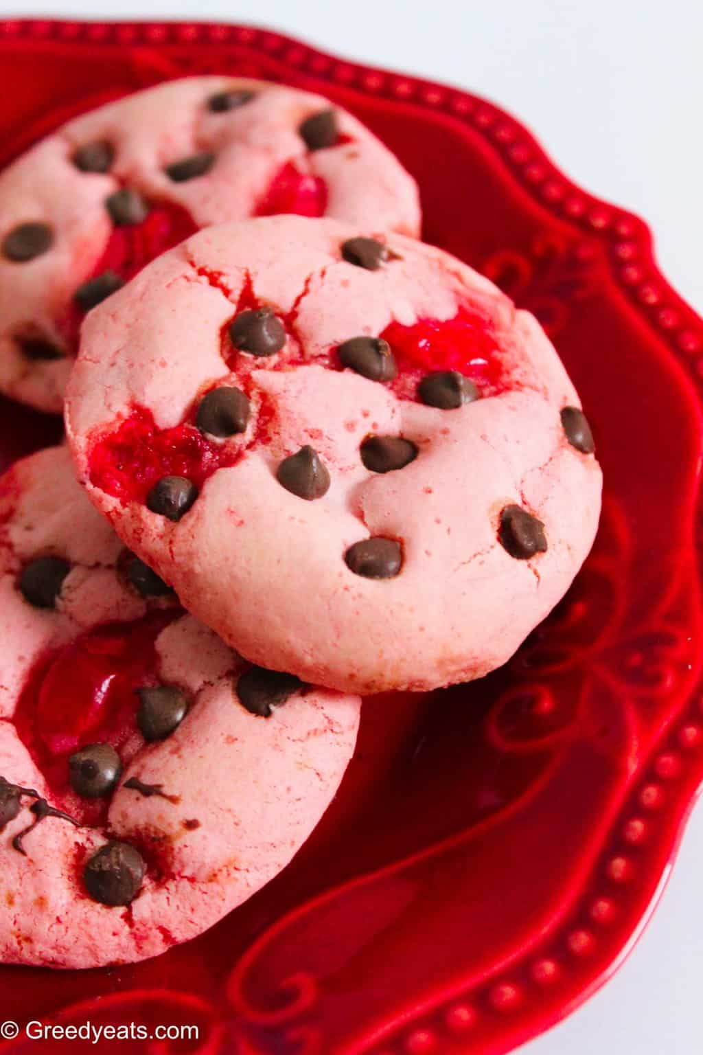 Strawberry chocolate chip cookies made with cake mix on a red plate.