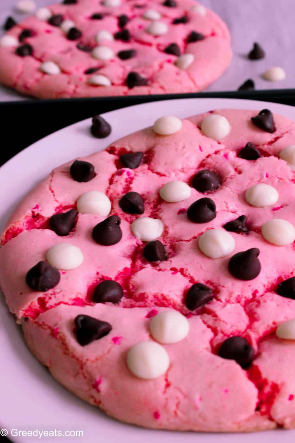 Super chewy and giant sugar cookie recipe topped with semi sweet chocolate chips and white chocolate chips. A perfect Valentines day cookie!