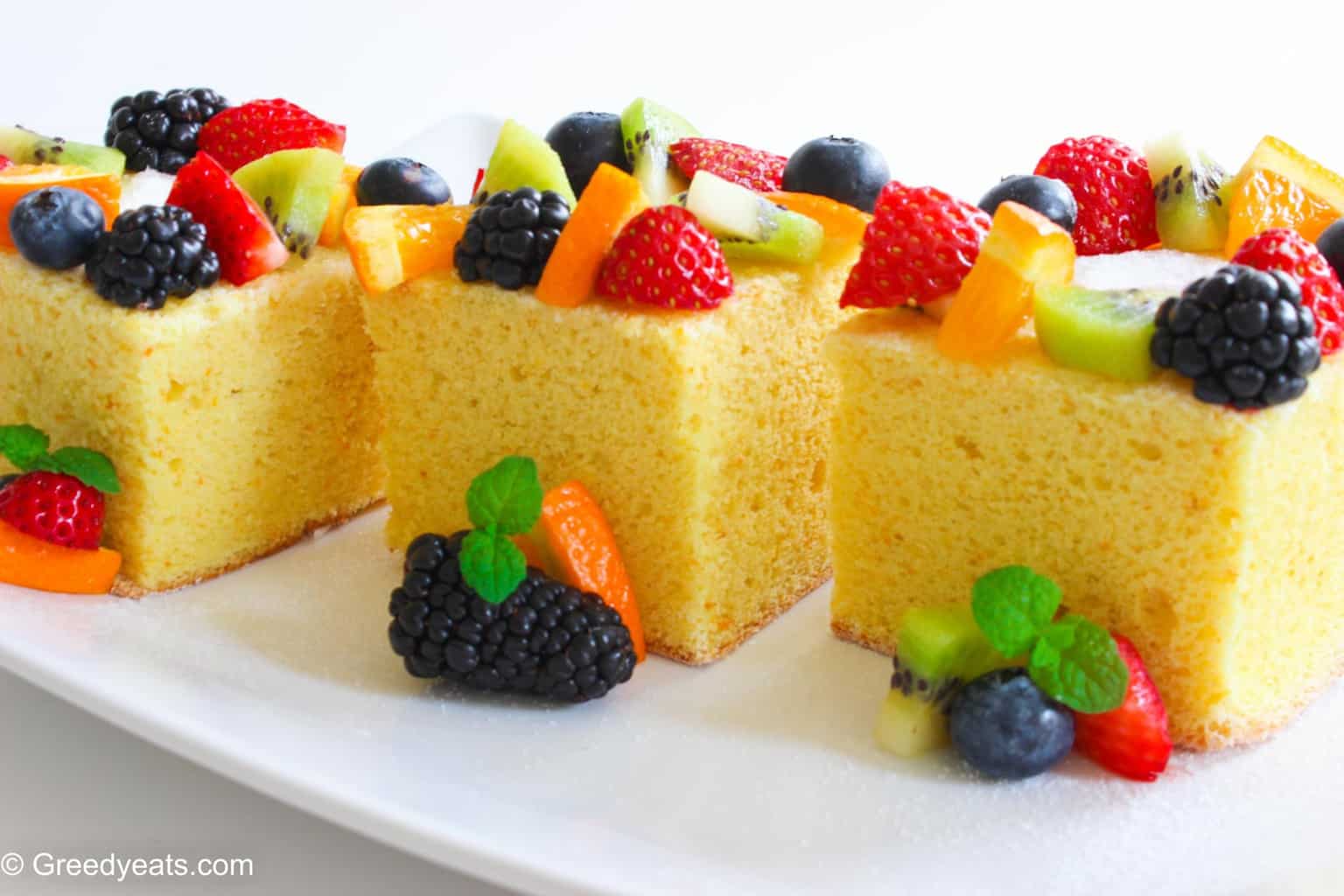 Pieces of small lemon cake that are spongy, soft and fluffy topped with fresh fruit. 