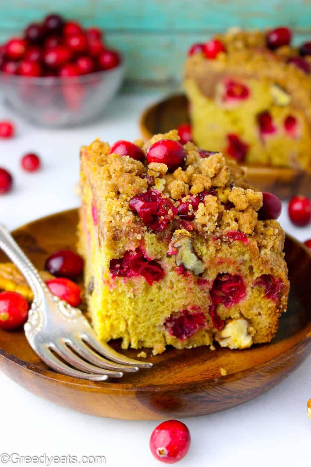 Two slices of Easy Buttermilk Coffee Cake with cranberries and toasty pecans.