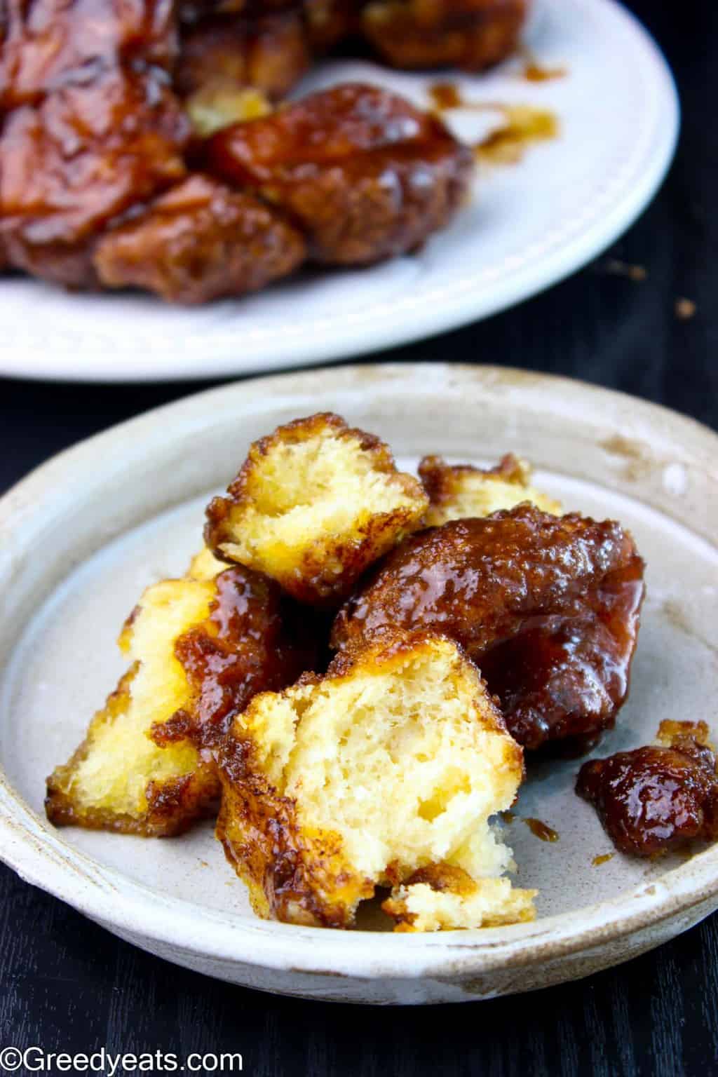 The BEST MONKEY BREAD that you will ever taste served on a ceramic plate.