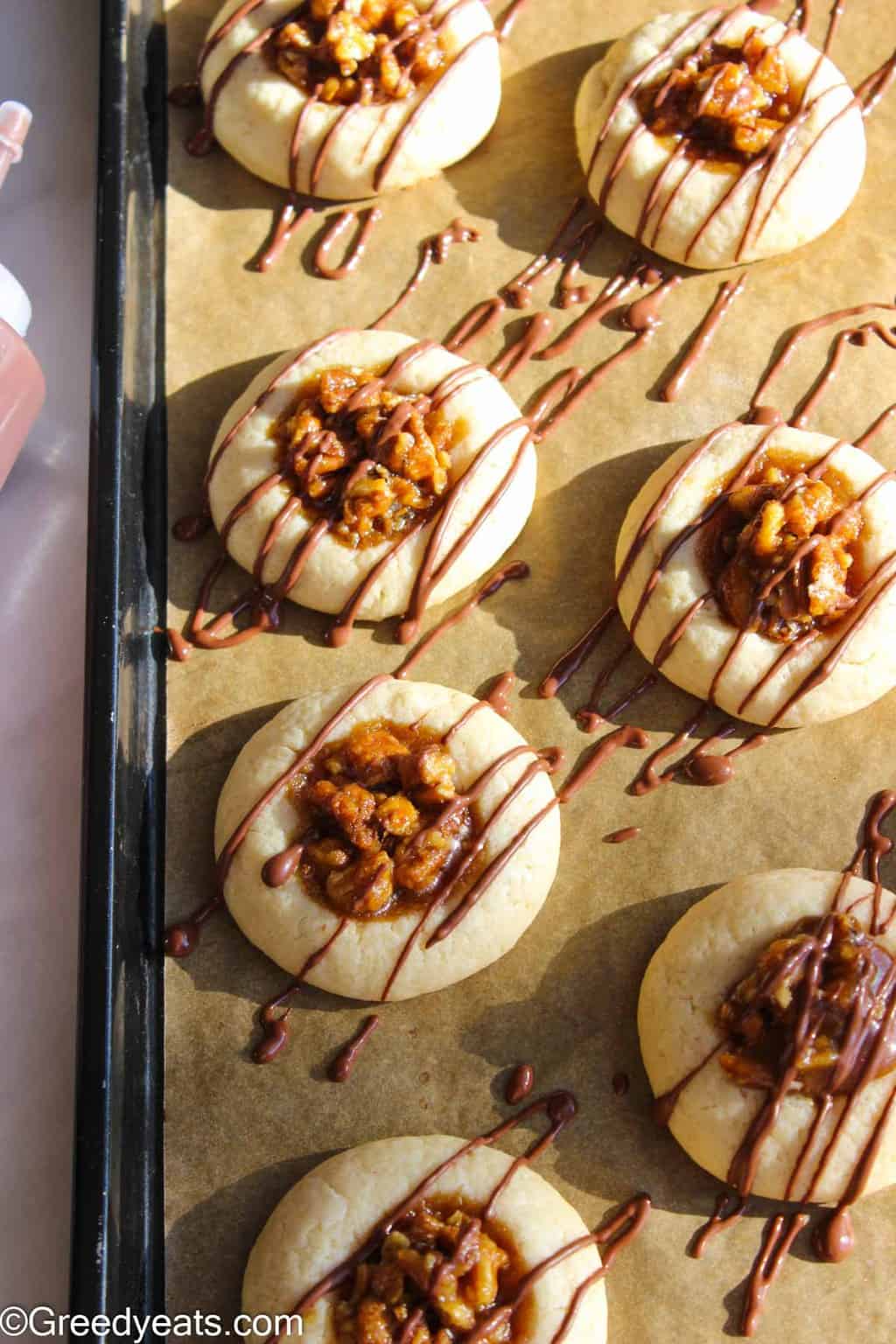 Pecan thumbprint cookies drizzled with melted chocolate will be your most favorite Hoilday cookies!