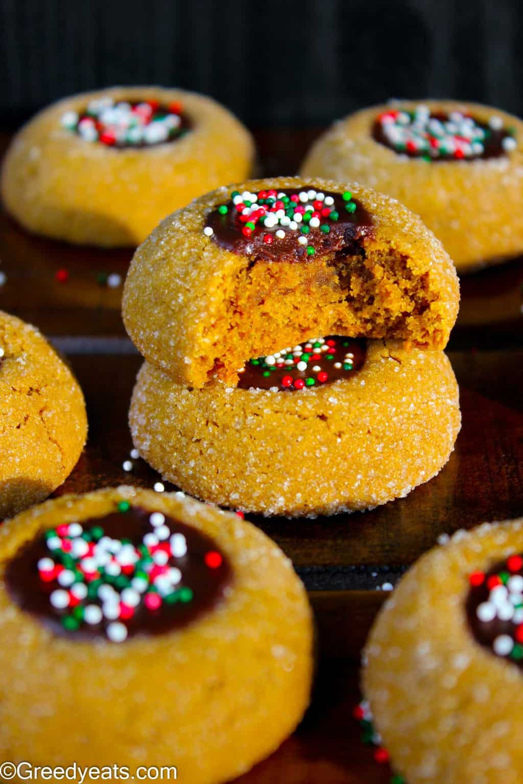 Soft, thick and chewy Molasses cookie recipe with chocolate filling and Christmas sprinkles.