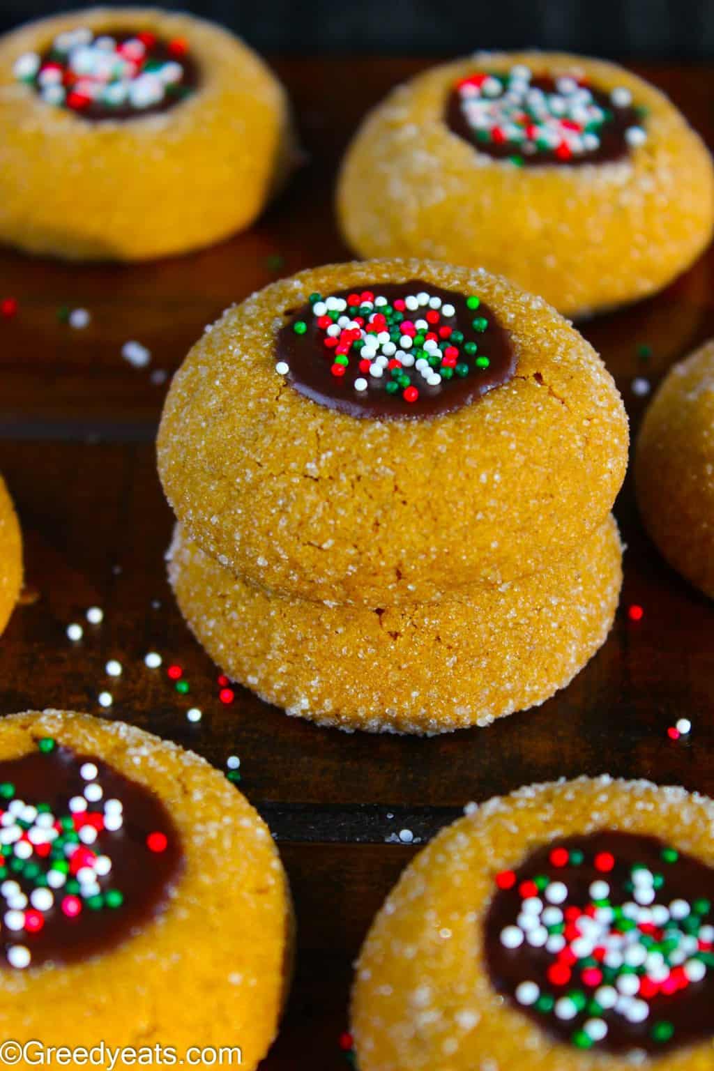 Puffy and soft Molasses Cookies with gingerbread flavors and a gooey chocolate filling studded with Christmas sprinkles.