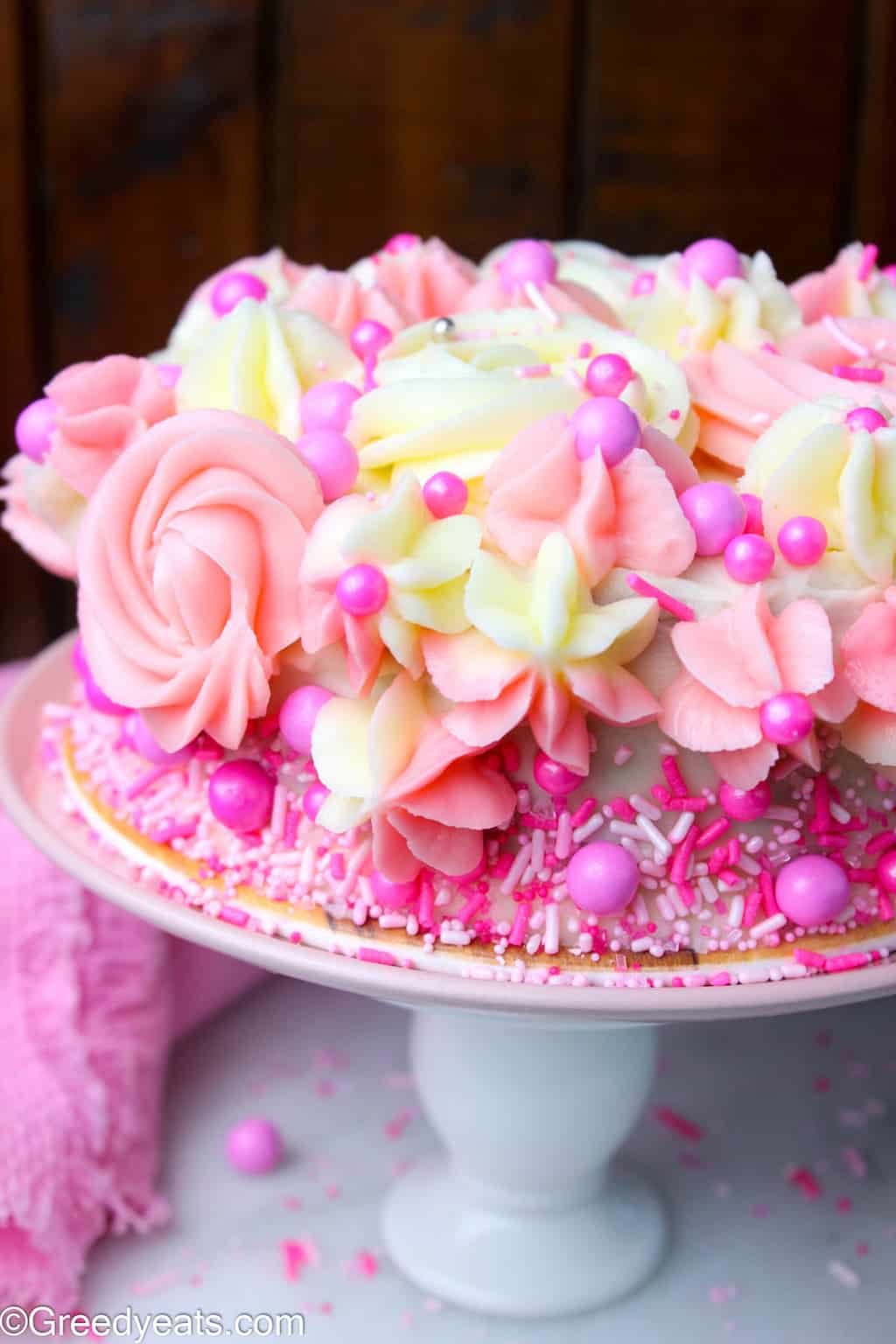 Single layer vanilla cake with pink vanilla frosting. Perfect as Valentines Cake recipe.