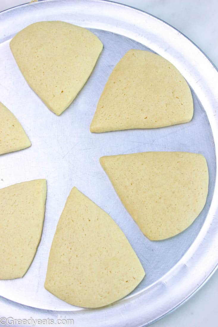 Soft baked sugar cookies cooling on a silver plate.