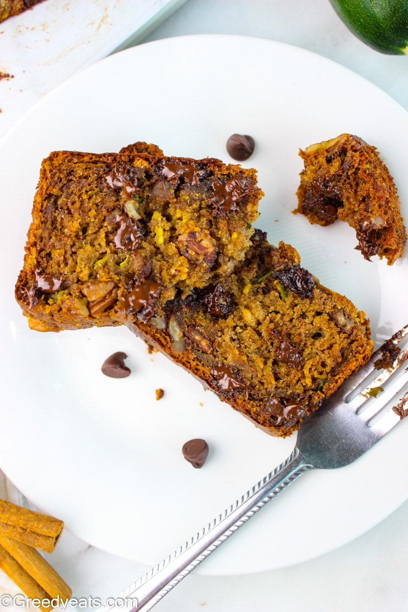 Close up shot of slices of moist and healthy Zucchini Bread on a white plate.