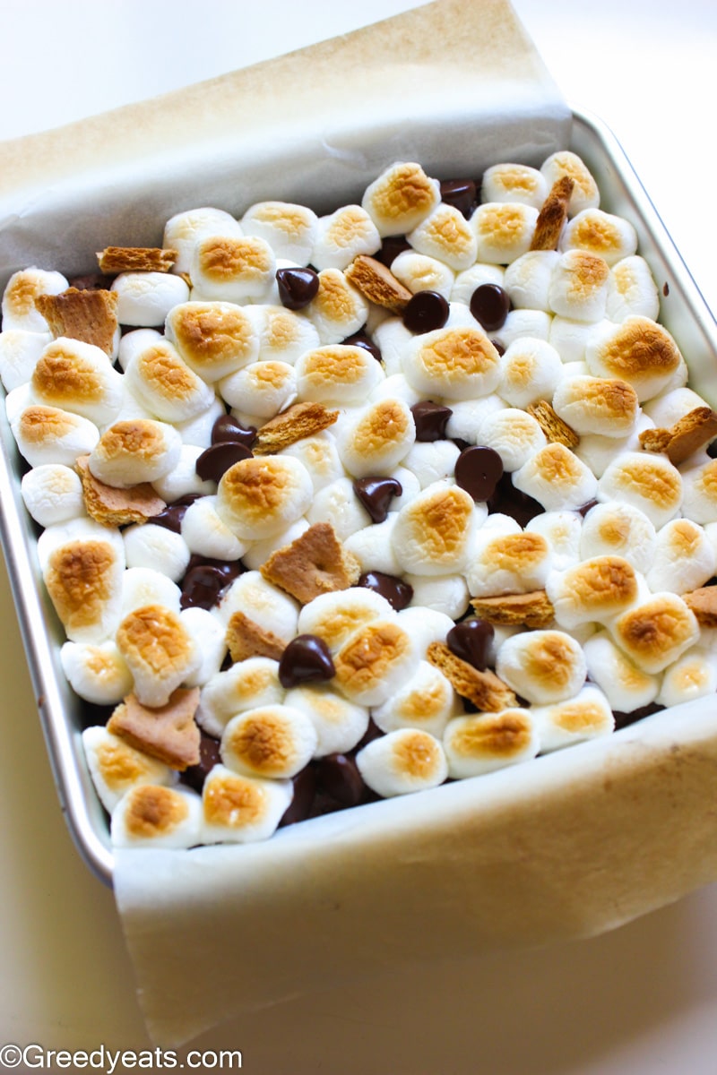 Toasted marshmallows, melty chocolate chips and golden graham cracker chunks on baked brownies.