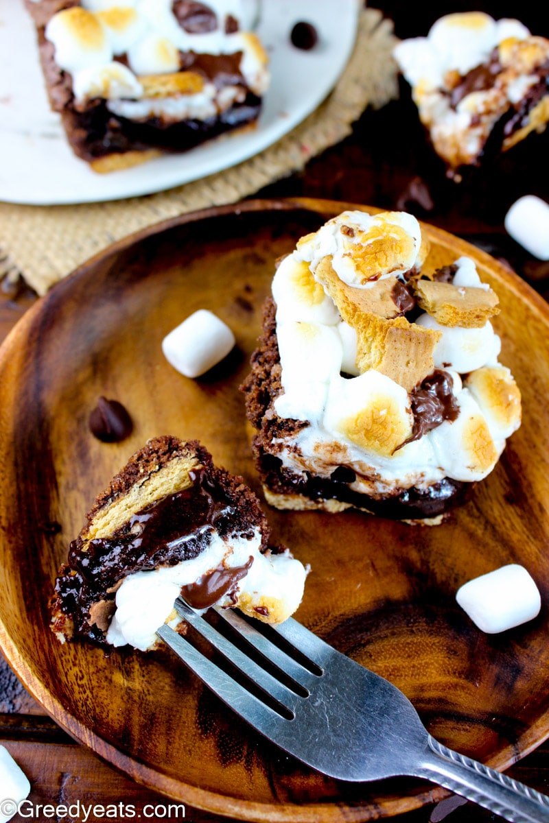 Homemade Smores Brownies recipe served on a brown wooden plate.