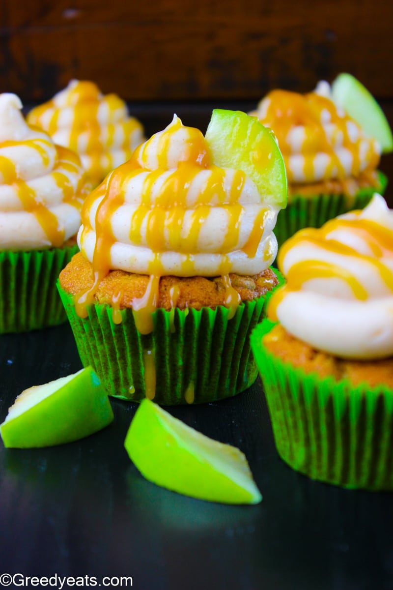 Caramel Apple Cupcakes topped with cream cheese frosting and homemade caramel.