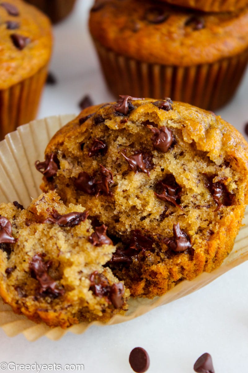 Close up shot of soft and fluffy Healthy Banana Muffins wrapped in muffin liners.