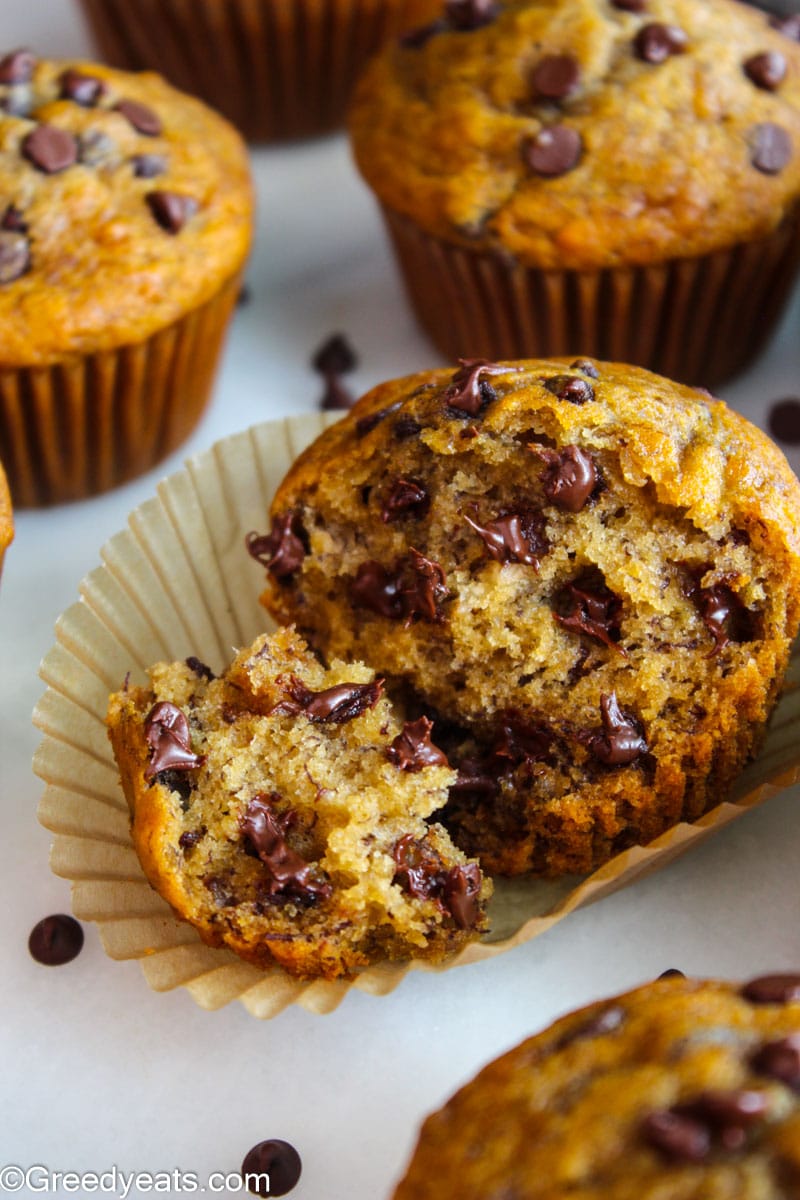 Freshly baked Healthy Banana Chocolate Chip Muffins in a parchment paper liner.