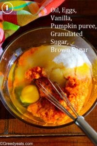 Wet ingredients like canned pumpkin, oil, sugar and eggs for making the easiest Pumpkin Bars ever!